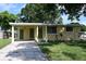 Charming home featuring a covered entry and well-maintained front yard landscaping at 11798 104Th St, Largo, FL 33773