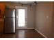 Well-lit kitchen area with stainless steel refrigerator, wood cabinets, and a view of the backyard at 11798 104Th St, Largo, FL 33773
