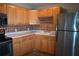 Bright kitchen featuring stainless steel appliances, light wood cabinets and a tile backsplash at 11798 104Th St, Largo, FL 33773