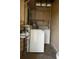 Laundry room features include a washer, dryer, and utility shelving for storage at 11798 104Th St, Largo, FL 33773