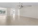 Bright living room featuring tile floors, ceiling fan, and neutral color scheme for versatile decorating at 1360 Franklin Ln, North Port, FL 34286