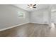A bedroom features wood-look floors, ceiling fan, one window, and neutral paint at 1415 Ridge Ave, Clearwater, FL 33755