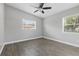 Bedroom with ceiling fan, wood-look flooring, and a large window at 1415 Ridge Ave, Clearwater, FL 33755