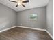 Bedroom with ceiling fan, wood-look flooring, and window at 1415 Ridge Ave, Clearwater, FL 33755