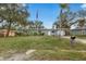 Charming single-story home featuring a well-maintained lawn and beautiful landscaping at 1415 Ridge Ave, Clearwater, FL 33755