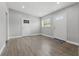 Bright living room with wood-look floors and a view into the entry hallway at 1415 Ridge Ave, Clearwater, FL 33755