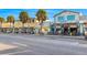 Street view of neighborhood restaurants and shops lined with Palm trees at 1415 Ridge Ave, Clearwater, FL 33755