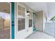 Exterior view of a private covered balcony with modern fixtures and ample natural light at 1946 Hammocks Ave, Lutz, FL 33549