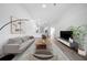 Bright living room with modern decor, neutral tones, and open view of the kitchen at 1946 Hammocks Ave, Lutz, FL 33549
