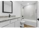 A well-lit bathroom with modern fixtures, granite counters, and a tiled shower at 1150 Huntington St, North Port, FL 34288