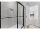 Modern bathroom featuring a frameless glass shower and a window to the backyard at 1150 Huntington St, North Port, FL 34288