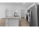 Open-concept kitchen with stainless steel appliances, granite countertops, and wood flooring at 1150 Huntington St, North Port, FL 34288