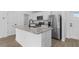 Modern kitchen with stainless steel appliances, granite countertops, and wood flooring at 1150 Huntington St, North Port, FL 34288