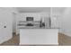 Contemporary kitchen boasts stainless steel appliances, granite counters, and wood floors at 1150 Huntington St, North Port, FL 34288