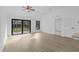 Bright living room featuring wood flooring, backyard access and a ceiling fan at 1150 Huntington St, North Port, FL 34288