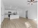 Open concept room with a kitchen featuring modern appliances and wood flooring at 1150 Huntington St, North Port, FL 34288
