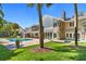 Gorgeous backyard featuring a pool, green grass, and a stone fireplace at 16403 Zurraquin De Avila, Tampa, FL 33613