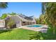 Home featuring an outdoor patio, swimming pool, and mature landscaping at 16403 Zurraquin De Avila, Tampa, FL 33613