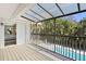 Covered patio with outdoor seating overlooking the pool area and lush tropical landscaping at 16403 Zurraquin De Avila, Tampa, FL 33613