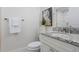 Powder room with white vanity, granite counters, and decorative art at 16403 Zurraquin De Avila, Tampa, FL 33613