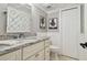 A beautifully decorated bathroom with granite counters, tile floor, and white cabinets at 16403 Zurraquin De Avila, Tampa, FL 33613