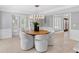 Open-concept dining room featuring travertine floors and ample natural light at 16403 Zurraquin De Avila, Tampa, FL 33613