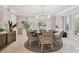 Formal dining room with a stylish chandelier, plantation shutters, and a cozy rug at 16403 Zurraquin De Avila, Tampa, FL 33613