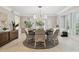 Light-filled dining room with elegant chandelier and many windows at 16403 Zurraquin De Avila, Tampa, FL 33613