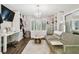 A stylish dressing room with a desk, TV, closet system, chandelier and comfortable sofa at 16403 Zurraquin De Avila, Tampa, FL 33613