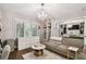 A dressing room with mirrored closet doors, sofa, closet system and decorative chandelier at 16403 Zurraquin De Avila, Tampa, FL 33613