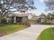Stunning two-story home with stone accents, a circular driveway, and manicured lawn at 16403 Zurraquin De Avila, Tampa, FL 33613