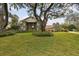 Grand home featuring well-maintained landscaping, stone accents, and a sprawling lawn at 16403 Zurraquin De Avila, Tampa, FL 33613