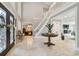 Bright foyer features stone floors, a staircase, and a view into the billiard room at 16403 Zurraquin De Avila, Tampa, FL 33613