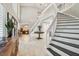 Bright foyer with staircase, tile floors, and clear view into living space beyond at 16403 Zurraquin De Avila, Tampa, FL 33613