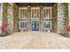 Charming stone front facade with large windows, shutters, and a beautiful front door at 16403 Zurraquin De Avila, Tampa, FL 33613