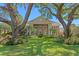 Beautiful two-story home with stone facade, mature landscaping, and large trees at 16403 Zurraquin De Avila, Tampa, FL 33613