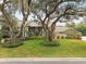 Beautiful home with mature trees, lush landscaping and a circular driveway at 16403 Zurraquin De Avila, Tampa, FL 33613