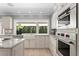 Updated kitchen featuring custom white cabinetry and stainless steel appliances at 16403 Zurraquin De Avila, Tampa, FL 33613