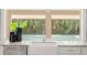 Bright kitchen sink with a view of the pool and backyard at 16403 Zurraquin De Avila, Tampa, FL 33613