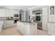 Kitchen island and stainless steel appliances in a contemporary kitchen at 16403 Zurraquin De Avila, Tampa, FL 33613