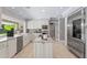 Bright kitchen featuring stainless steel appliances, white cabinetry and granite countertops at 16403 Zurraquin De Avila, Tampa, FL 33613