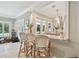 Stylish kitchen bar with seating, granite countertop, and pool view at 16403 Zurraquin De Avila, Tampa, FL 33613