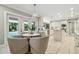 Bright kitchen with dining area, white cabinets, and double doors to the patio at 16403 Zurraquin De Avila, Tampa, FL 33613