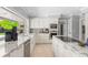 Bright kitchen featuring granite counters, stainless steel appliances, a farmhouse sink, and tile floors at 16403 Zurraquin De Avila, Tampa, FL 33613