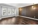 This bright living room features hardwood floors, large windows, and a unique accent wall at 16403 Zurraquin De Avila, Tampa, FL 33613