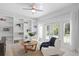 Comfortable living room with white wood paneled walls, built-in bookshelves, and a view to the backyard at 16403 Zurraquin De Avila, Tampa, FL 33613