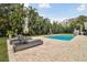 Private pool surrounded by tropical landscaping and brick pavers offers a relaxing outdoor space at 16403 Zurraquin De Avila, Tampa, FL 33613
