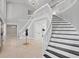 Grand foyer with a winding staircase, travertine tile, and elegant chandelier at 16403 Zurraquin De Avila, Tampa, FL 33613