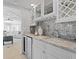 Elegant wet bar featuring granite countertops, wine racks, and glass storage at 16403 Zurraquin De Avila, Tampa, FL 33613