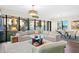 Bright and airy living room with large windows, a plush sofa, area rug, and an adjacent dining area at 199 Dali Blvd # 407, St Petersburg, FL 33701